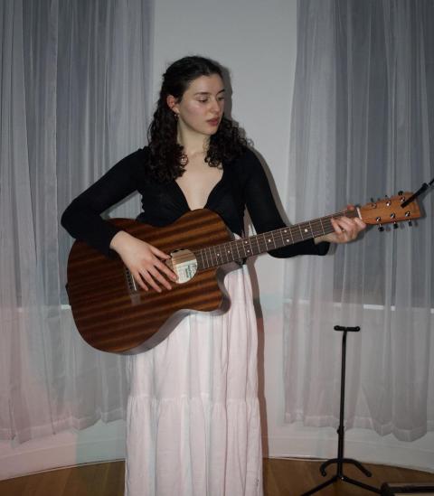Vanessa Torre playing the guitar